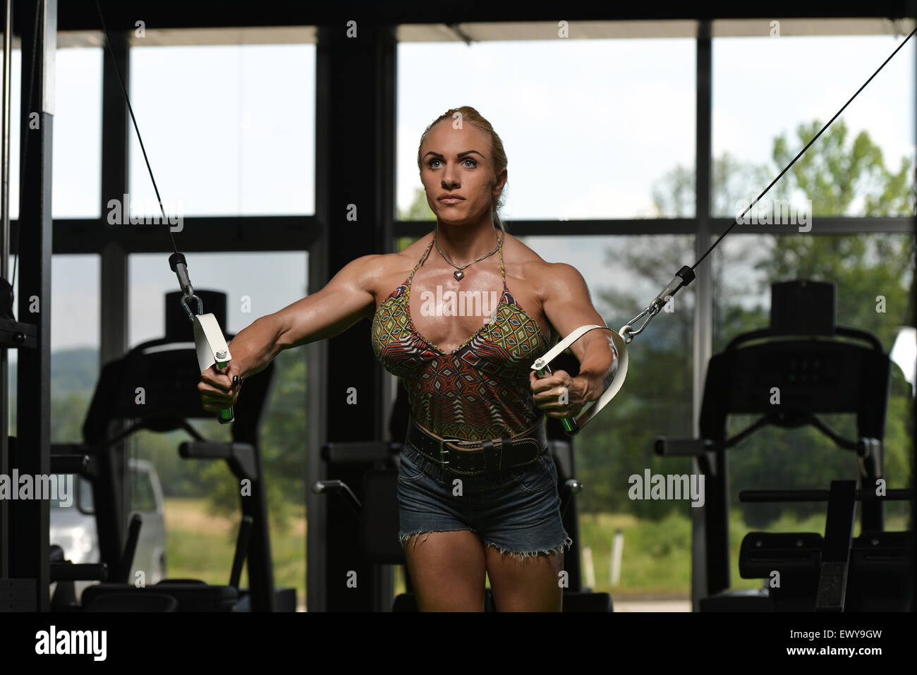 Premium Photo  Woman bodybuilder is working on her chest with cable  crossover in gym