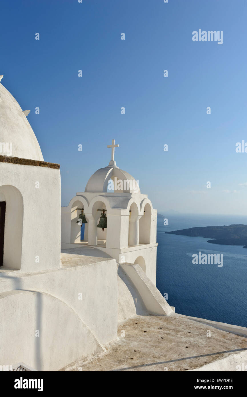 An Orthodox church with white dome and bell tower on the Caldera, Fira, Santorini, Greece. Stock Photo