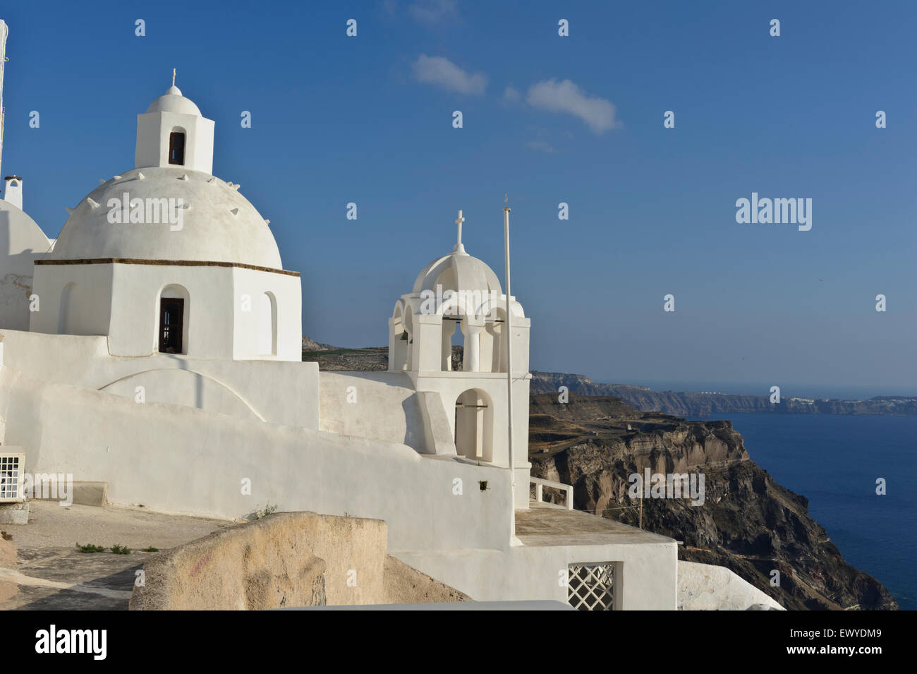 An Orthodox church with white dome and bell tower on the Caldera, Fira, Santorini, Greece. Stock Photo