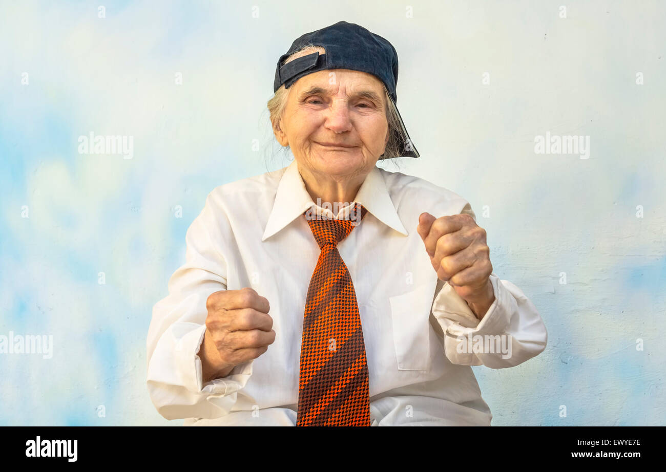 Funny elderly woman supporting something.  Selective focus Stock Photo