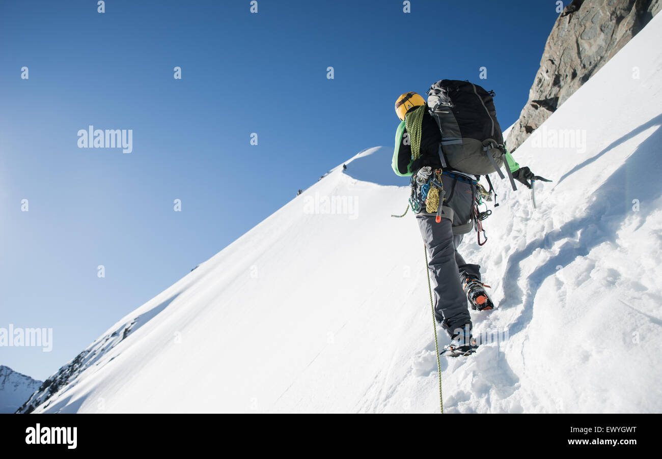 Man mountain climbing at Bianco Ridge, Swiss Alps, Bernina region, Switzerland Stock Photo