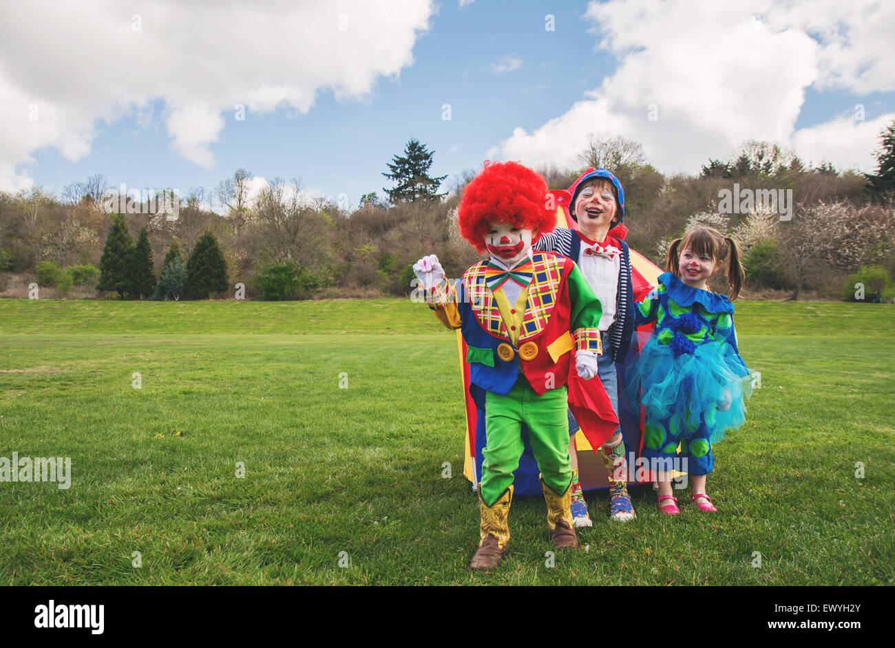 Three children dressed as clowns Stock Photo