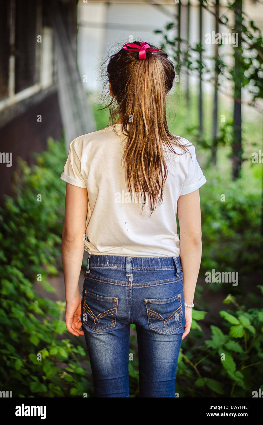 Rear view of a girl standing in a garden Stock Photo