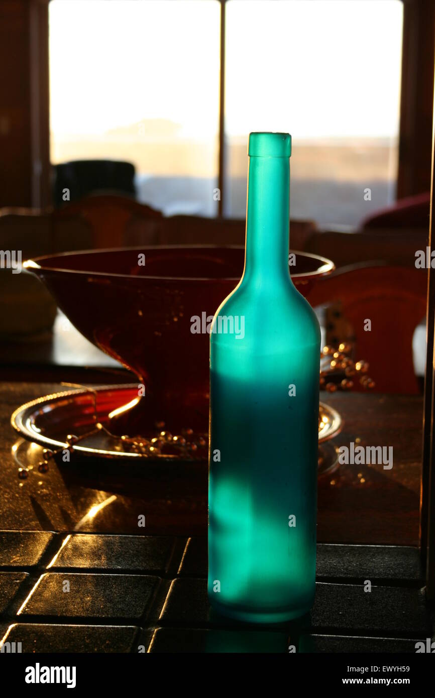 Translucent teal wine bottle with shadows. Stock Photo