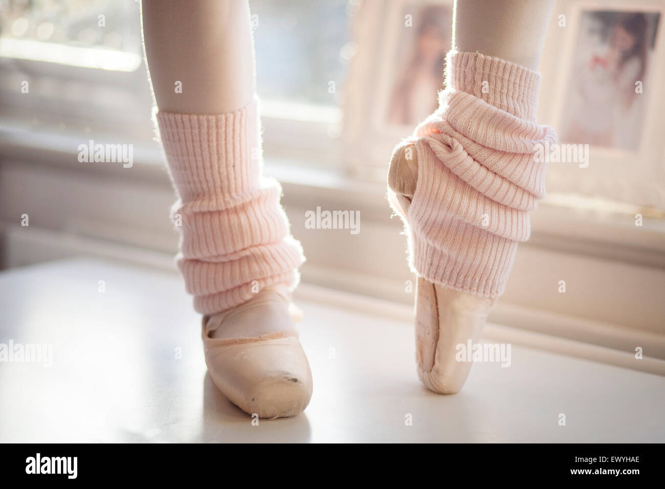 CloseUp of Ballerina Feet in Pointer Shoes and leg warmers Stock Photo