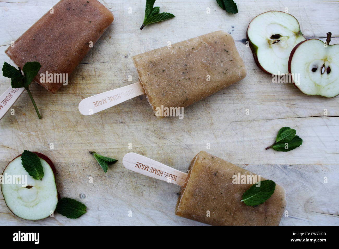 Closeup of apple and mint ice lollies, apple slices and mint leaves