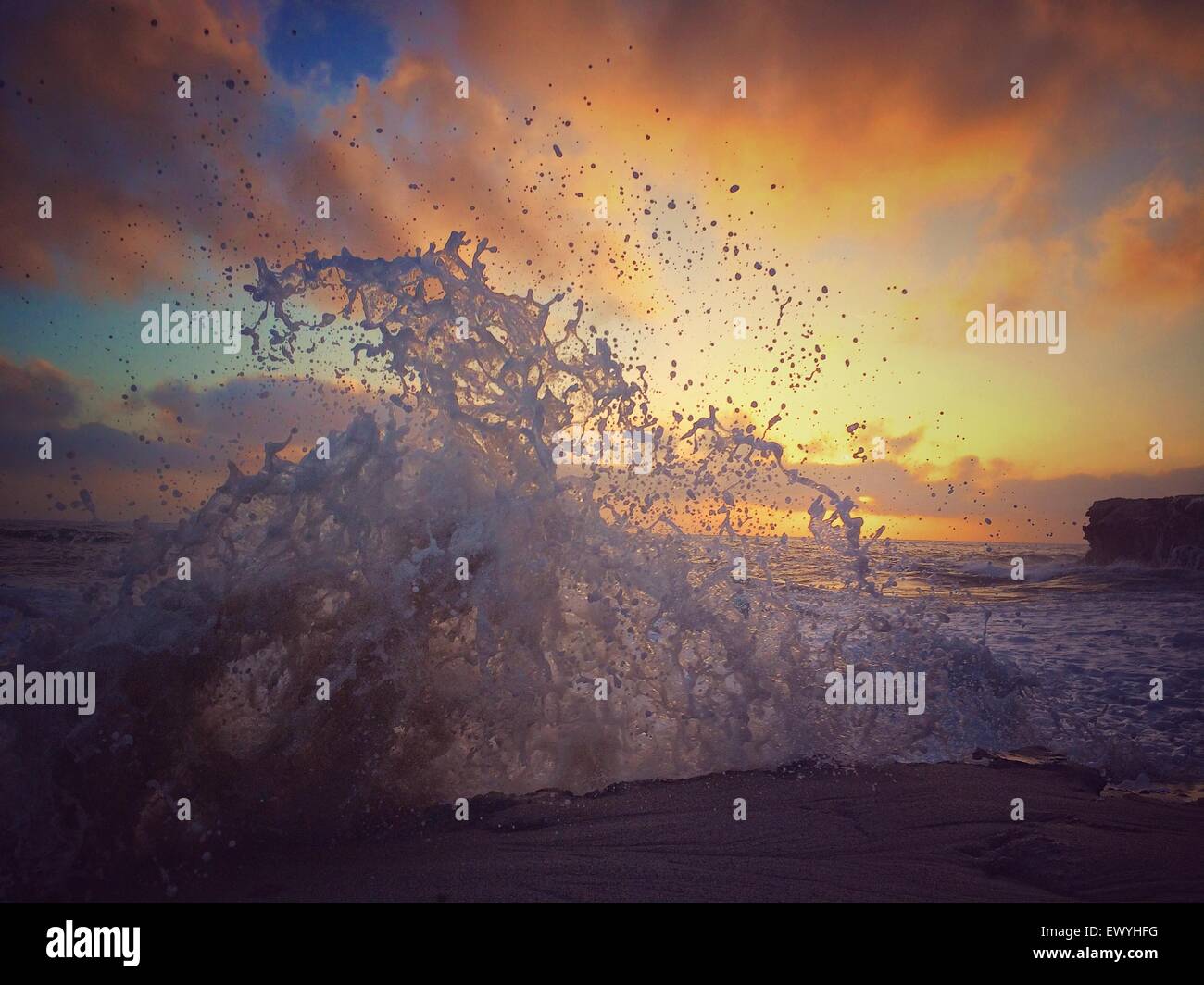 Waves crashing against rocks Stock Photo