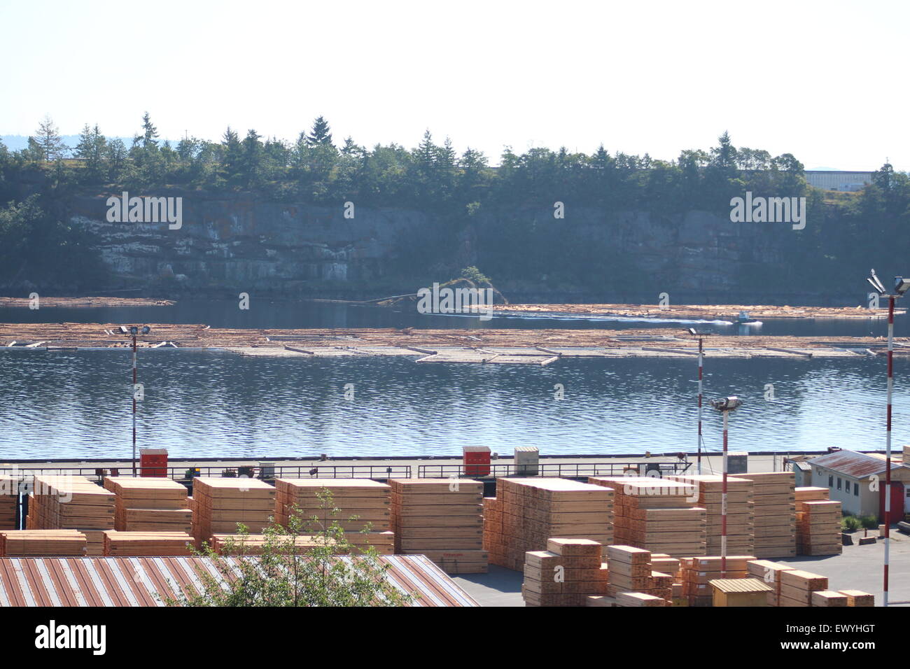 Ideal Backdrop of Lumber wood yard in Canada British Columbia, Beautiful inlet, lake water Stock Photo