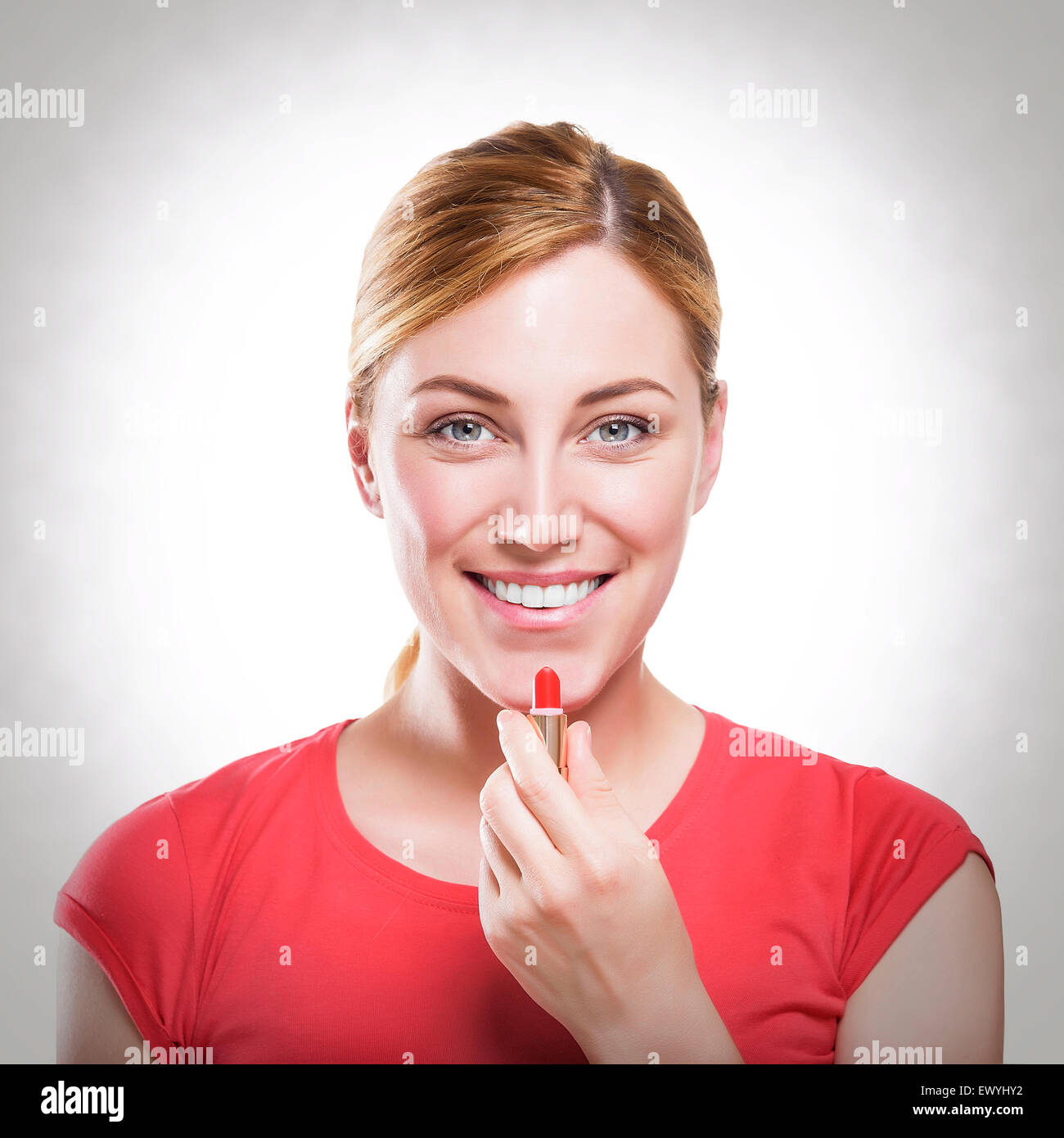 Woman applying lipstick Stock Photo Alamy
