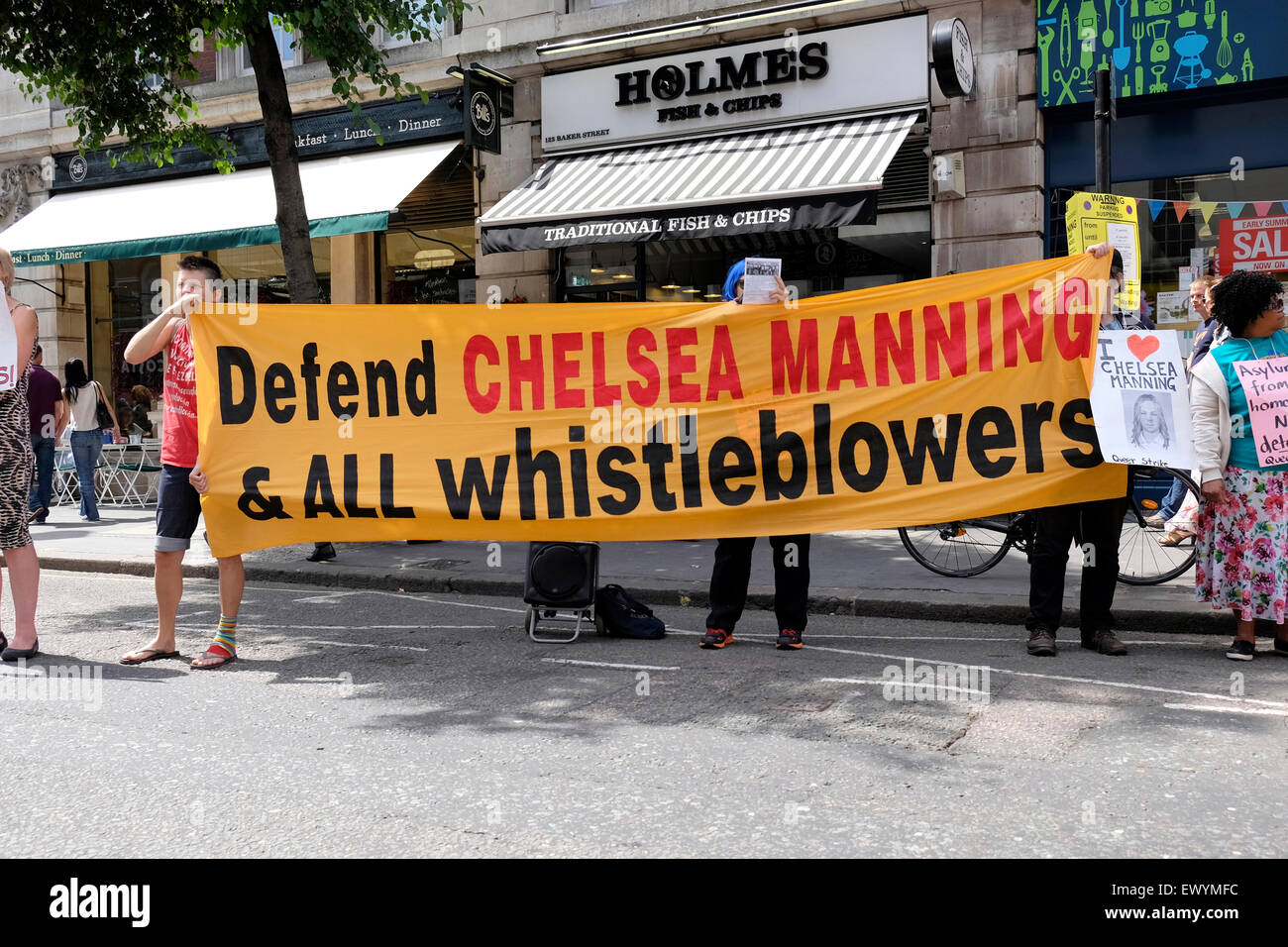 People hold a banner reading “ Defend Chelsea Manning and all whistle blowers ' Stock Photo