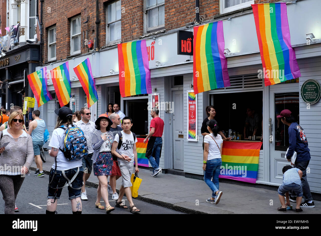 People walk past a pub decorated with gay flags, Soho, London Stock Photo Alamy
