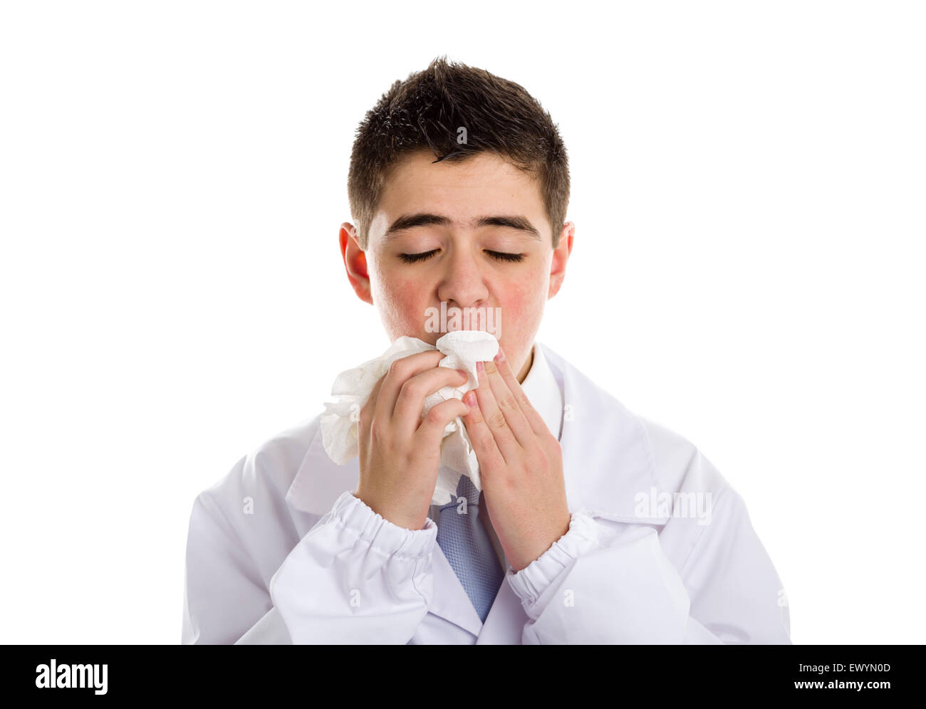 A boy doctor in white coat and blue tie helps to feel medicine more friendly: he is cleaning his lips with handkerchief.. His acne skin has not ben retouched Stock Photo