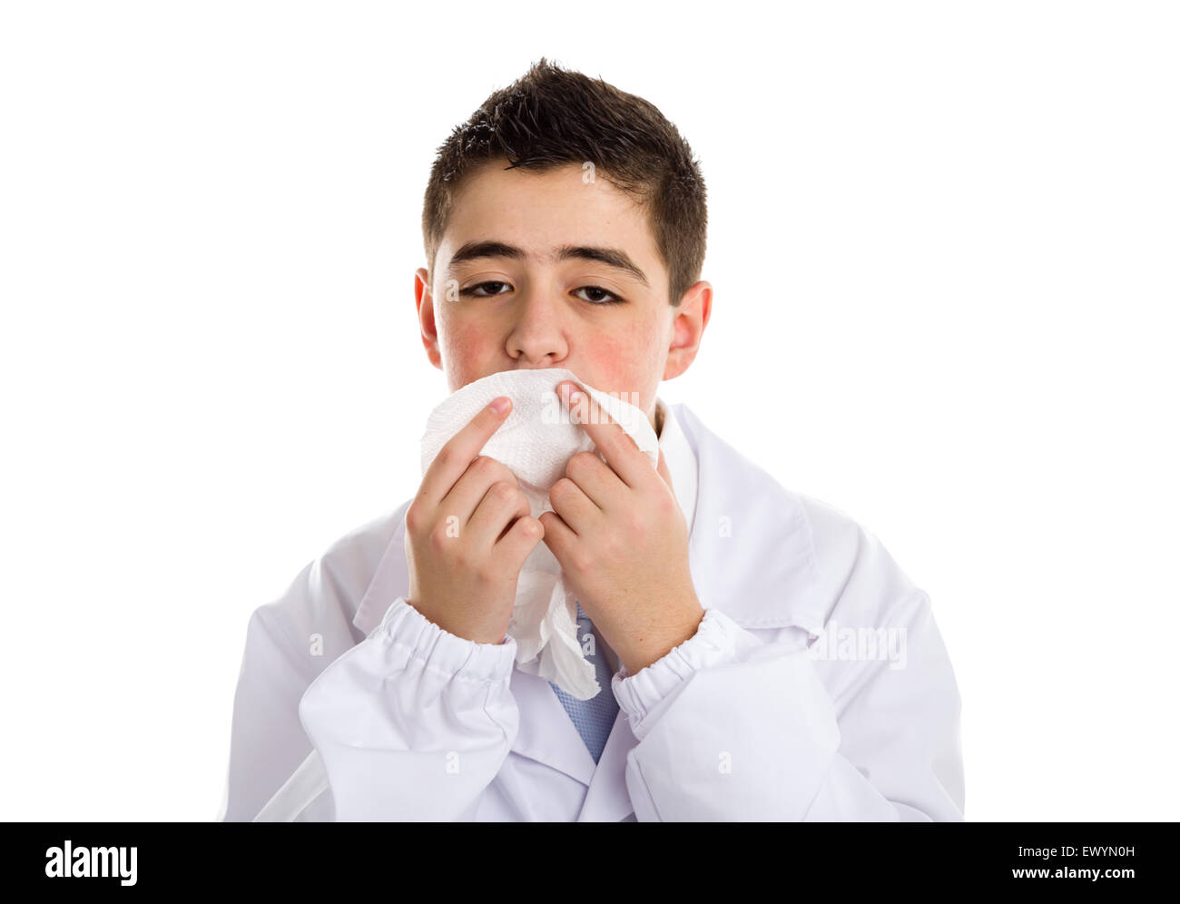 A boy doctor in white coat and blue tie helps to feel medicine more friendly: he is cleaning his lips with handkerchief.. His acne skin has not ben retouched Stock Photo