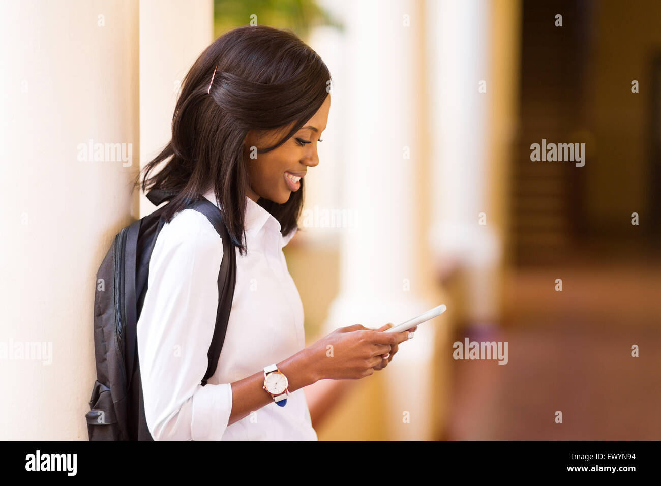 pretty female afro American university student using cell phone Stock ...