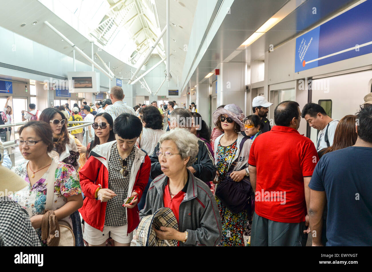 Chinese tourists visiting Dubai, UAE, in the skytrain metro station of Palm Jumeirah Stock Photo