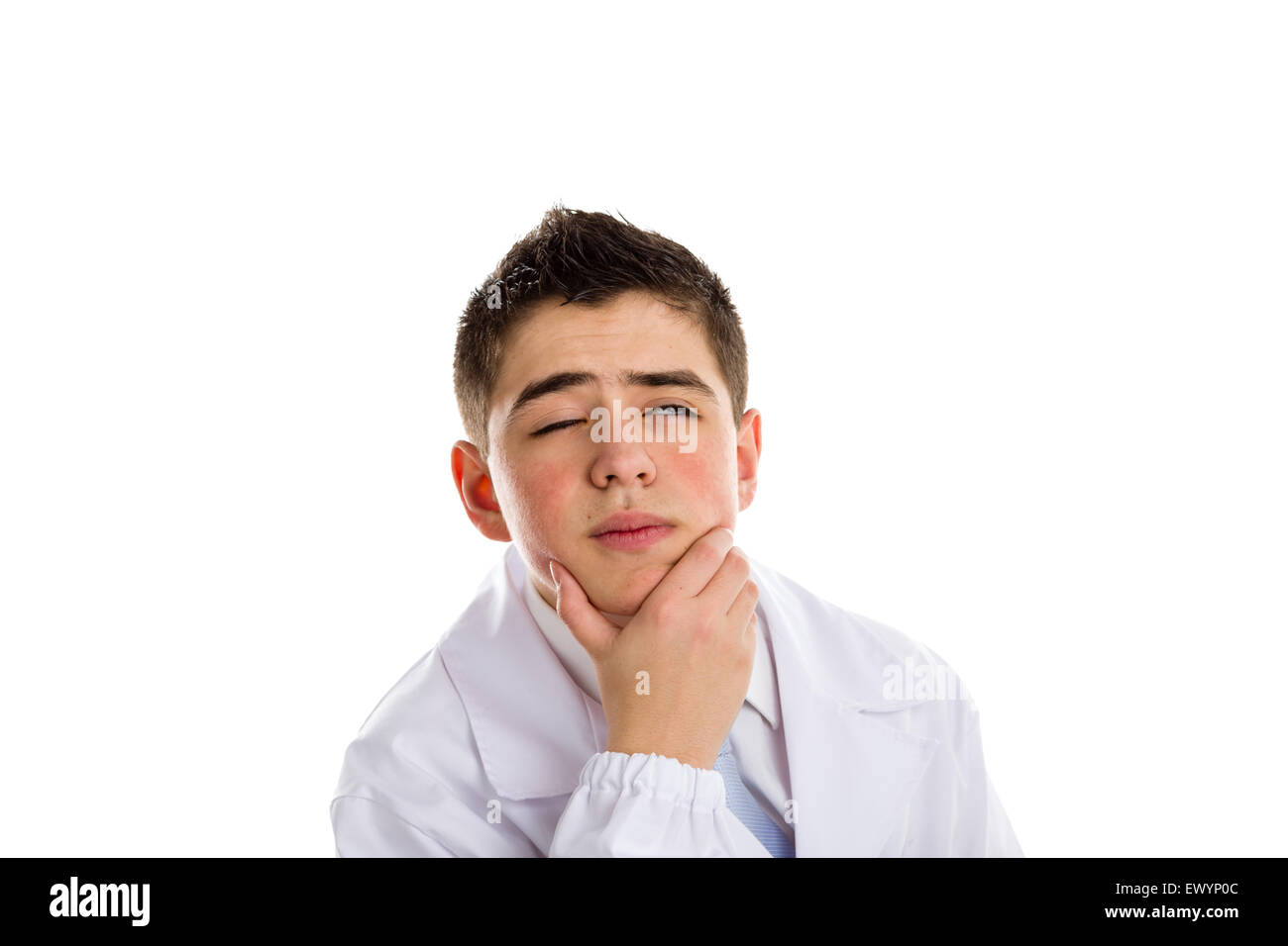 A boy doctor in blue tie and white coat holding his chin while thinking. His acne skin has not ben retouched Stock Photo