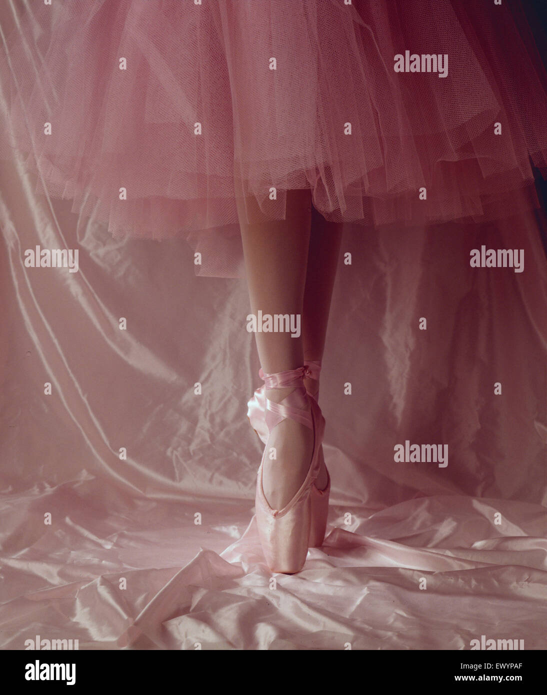 Legs of a ballet dancer, wearing toe shoes, in pink tights and tutu, on ...