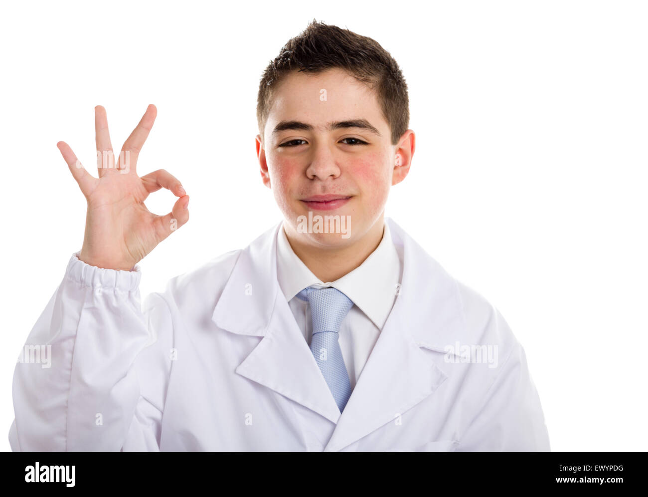 A boy doctor in white coat and blue tie helps to feel medicine more friendly: he is making OK sign. His acne skin has not ben retouched Stock Photo