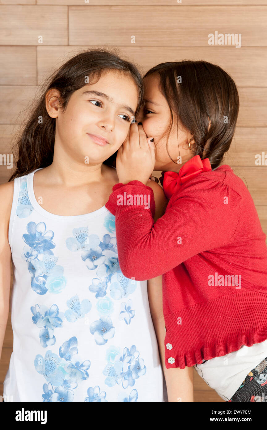 Two Children, one tell a secret to the other. Stock Photo