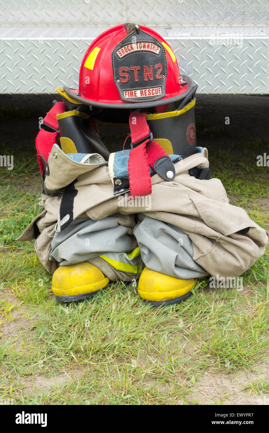 Fire fighter's protective gear together on the ground Stock Photo
