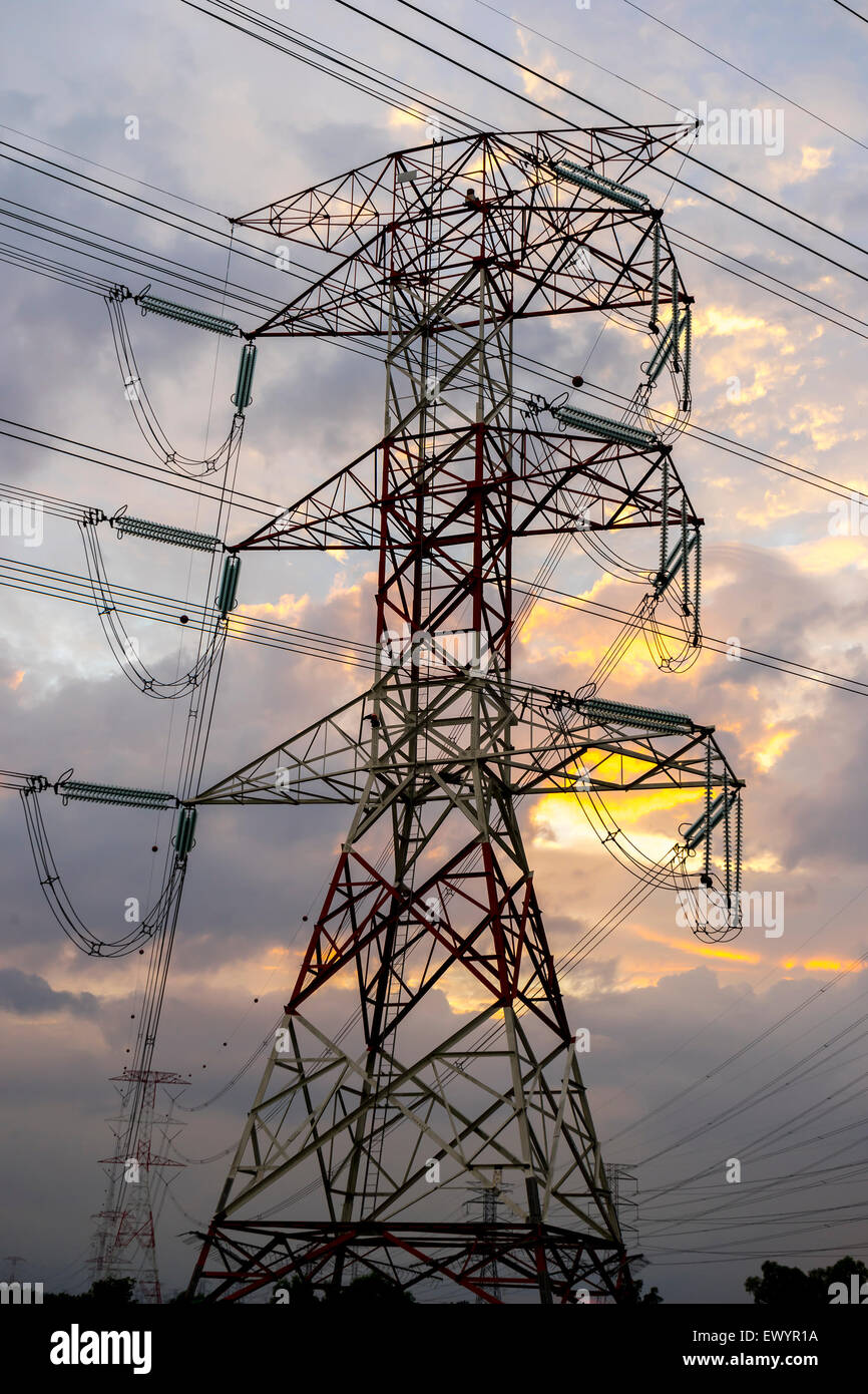 Electricity pylons and cable lines during sunset Stock Photo - Alamy
