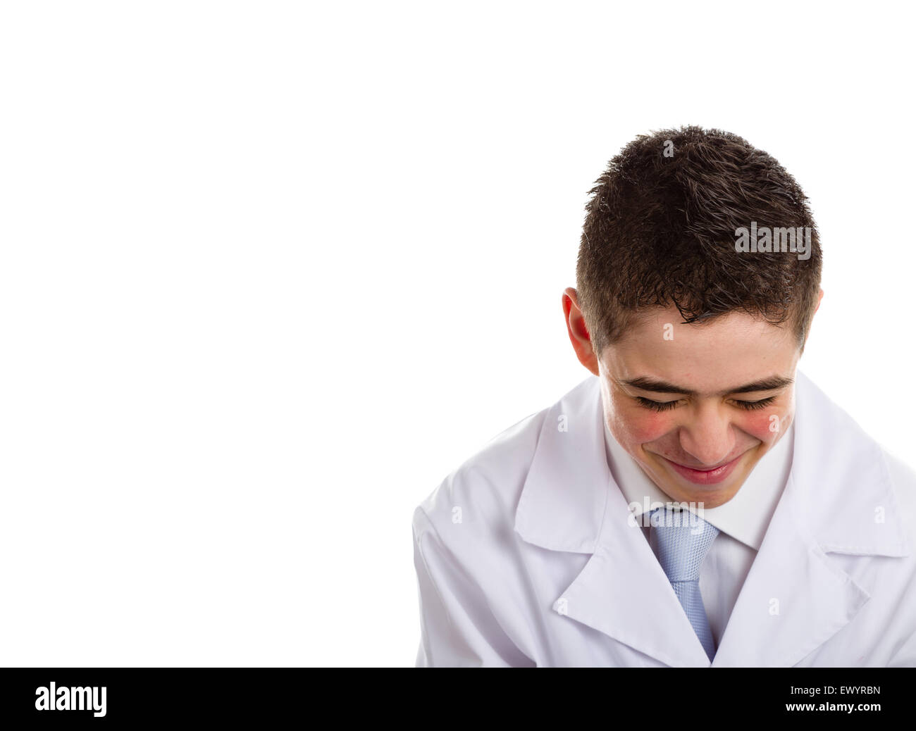 A boy doctor in white coat and blue tie helps to feel medicine more friendly: he is smiling. His acne skin has not ben retouched Stock Photo
