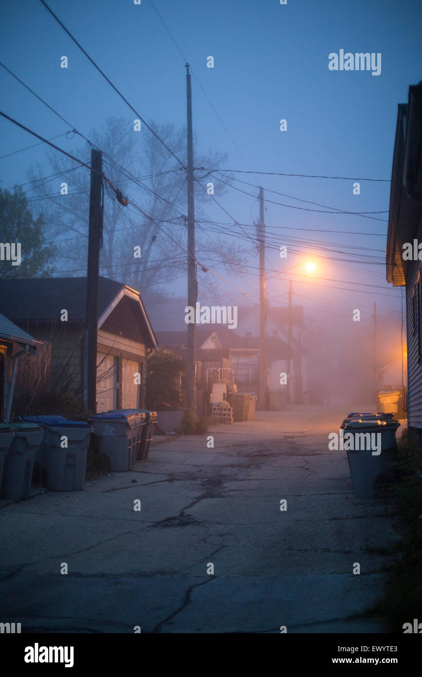 A foggy urban landscape at dusk in an alley Stock Photo