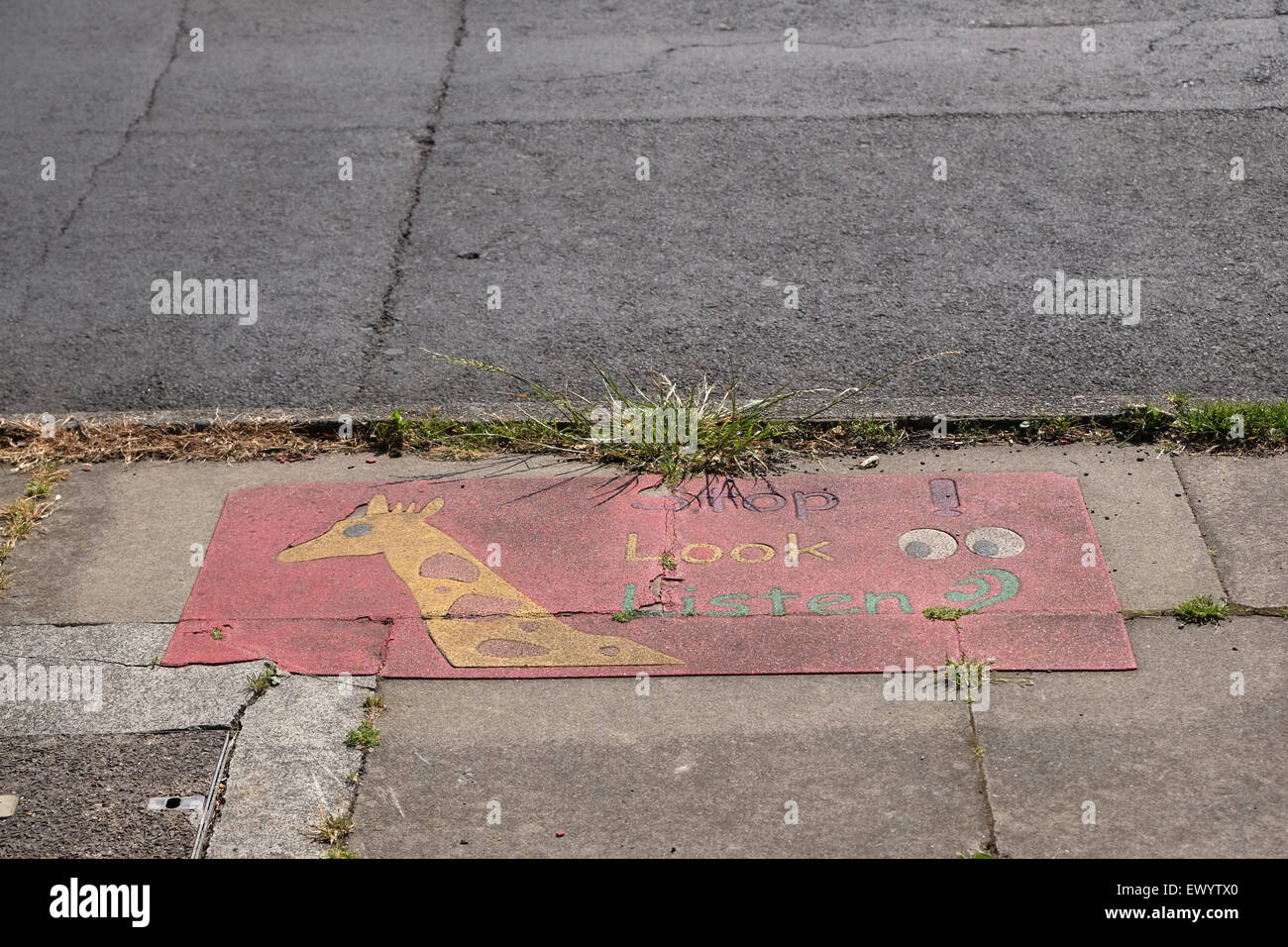 STOP LOOK LISTEN and don't trip up, a deteriorated child road safety sign. Stock Photo