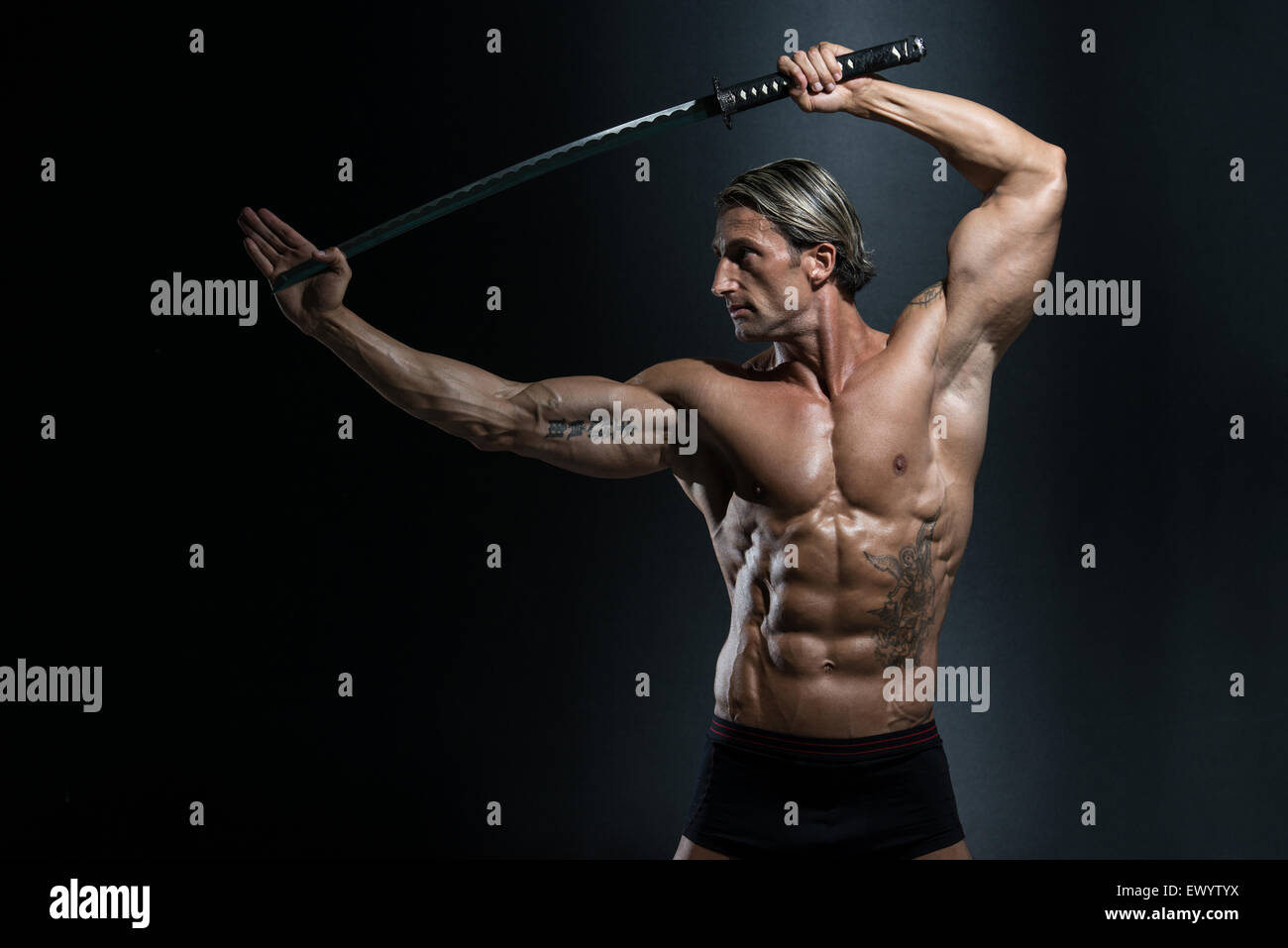 Portrait Of A Handsome Muscular Ancient Warrior With A Sword Stock ...