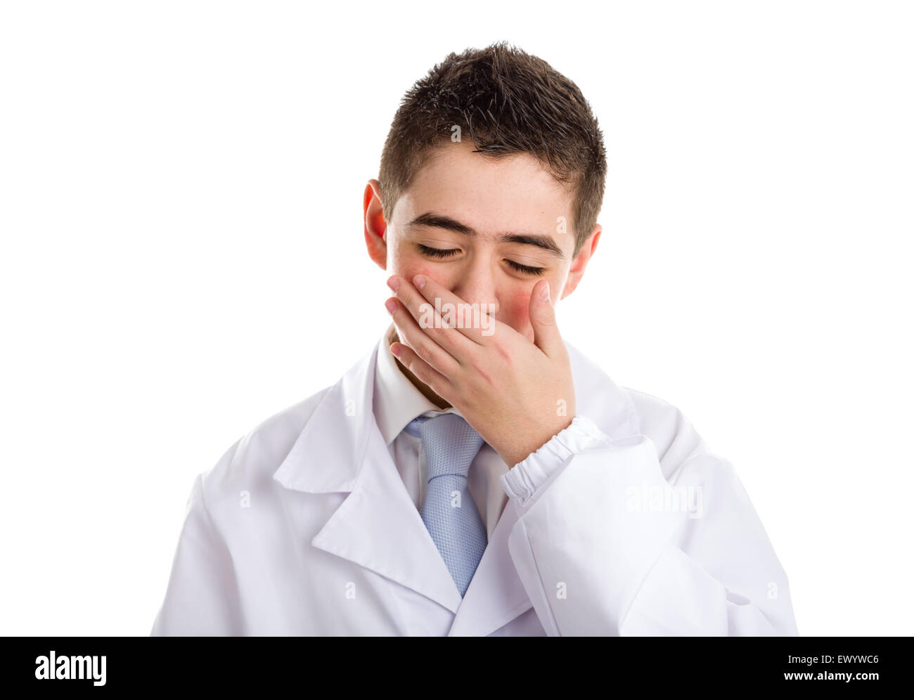 A boy doctor in white coat and blue tie helps to feel medicine more friendly: he is touching his nose. His acne skin has not ben retouched Stock Photo