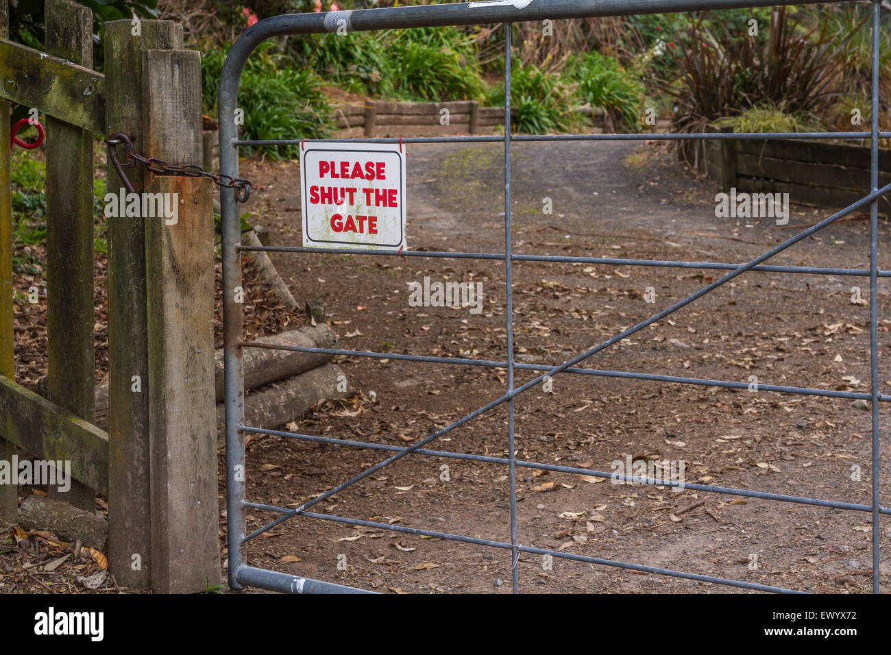Farm gate with shut the gate sign Stock Photo
