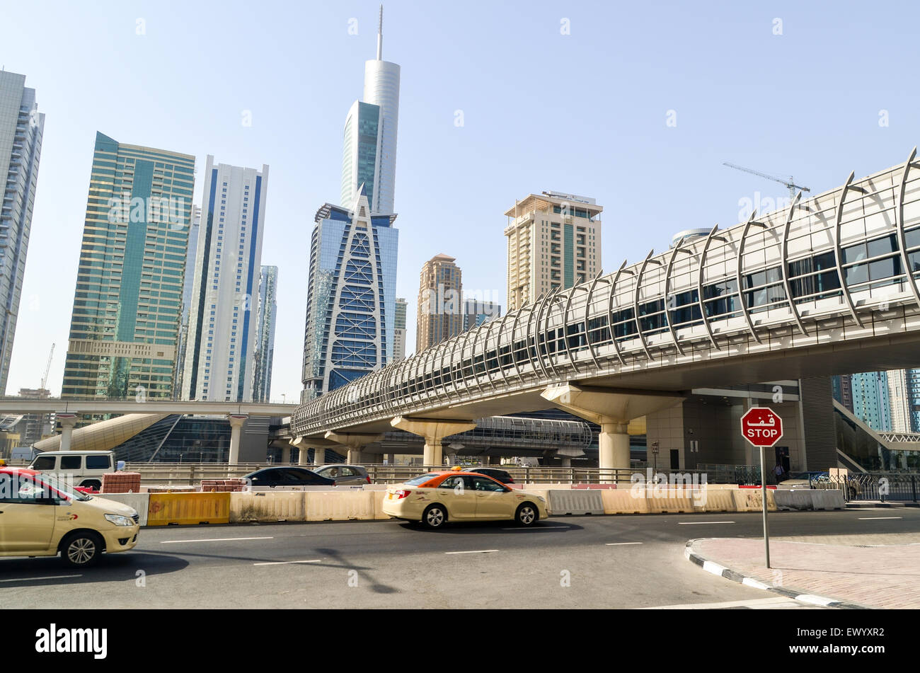 Jumeirah Lake Towers, near Dubai Marina, UAE, and bridge over the highway to the metro station Stock Photo