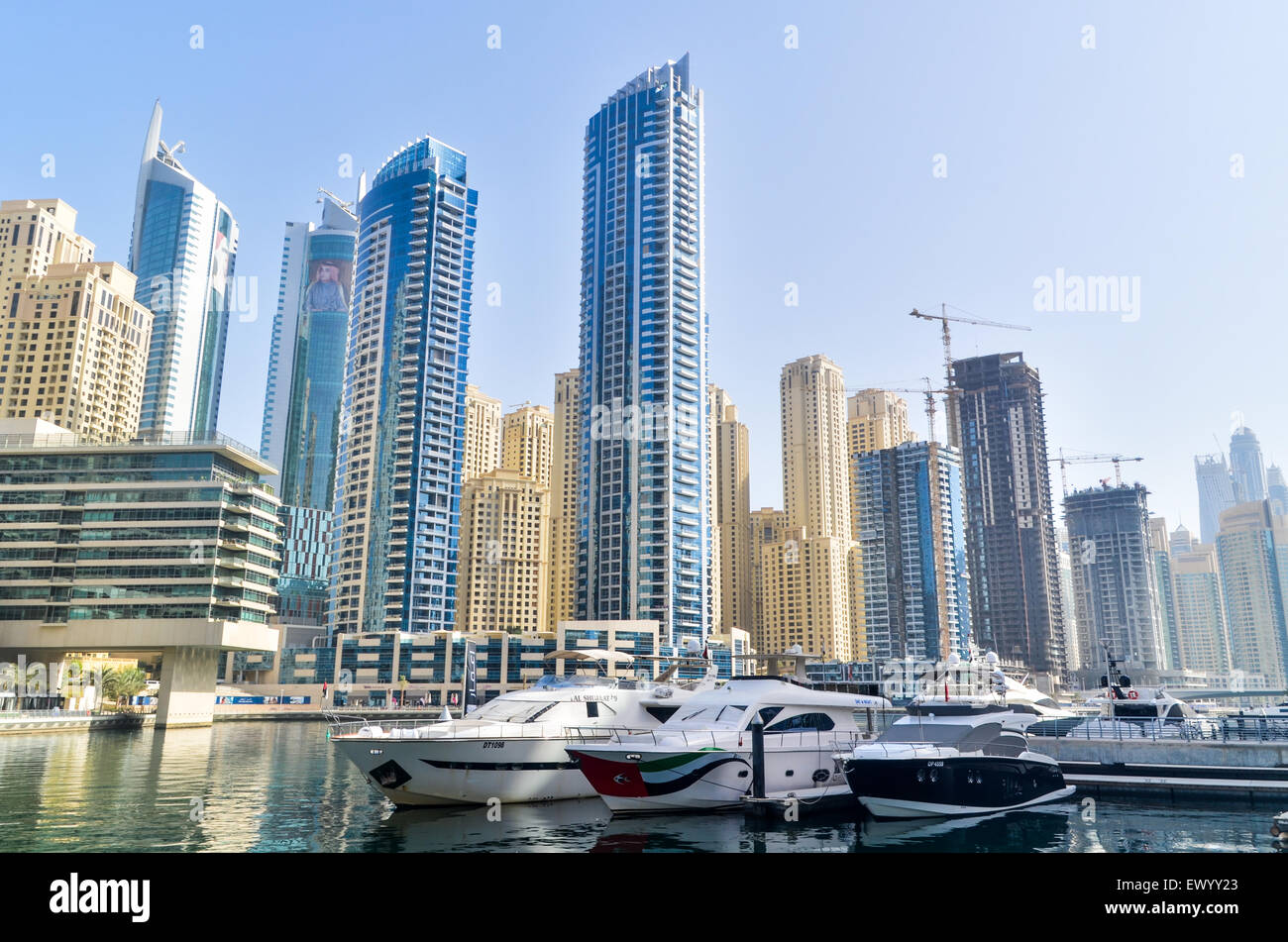 Luxury yachts and futuristic and modern high rise buildings, towers and hotels of the Dubai Marina, United Arab Emirates Stock Photo