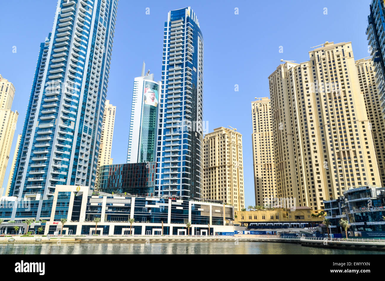 Face of Mohammed bin Rashid Al Maktoum, Emir of Dubai, among high rise buildings of the Dubai Marina, UAE Stock Photo