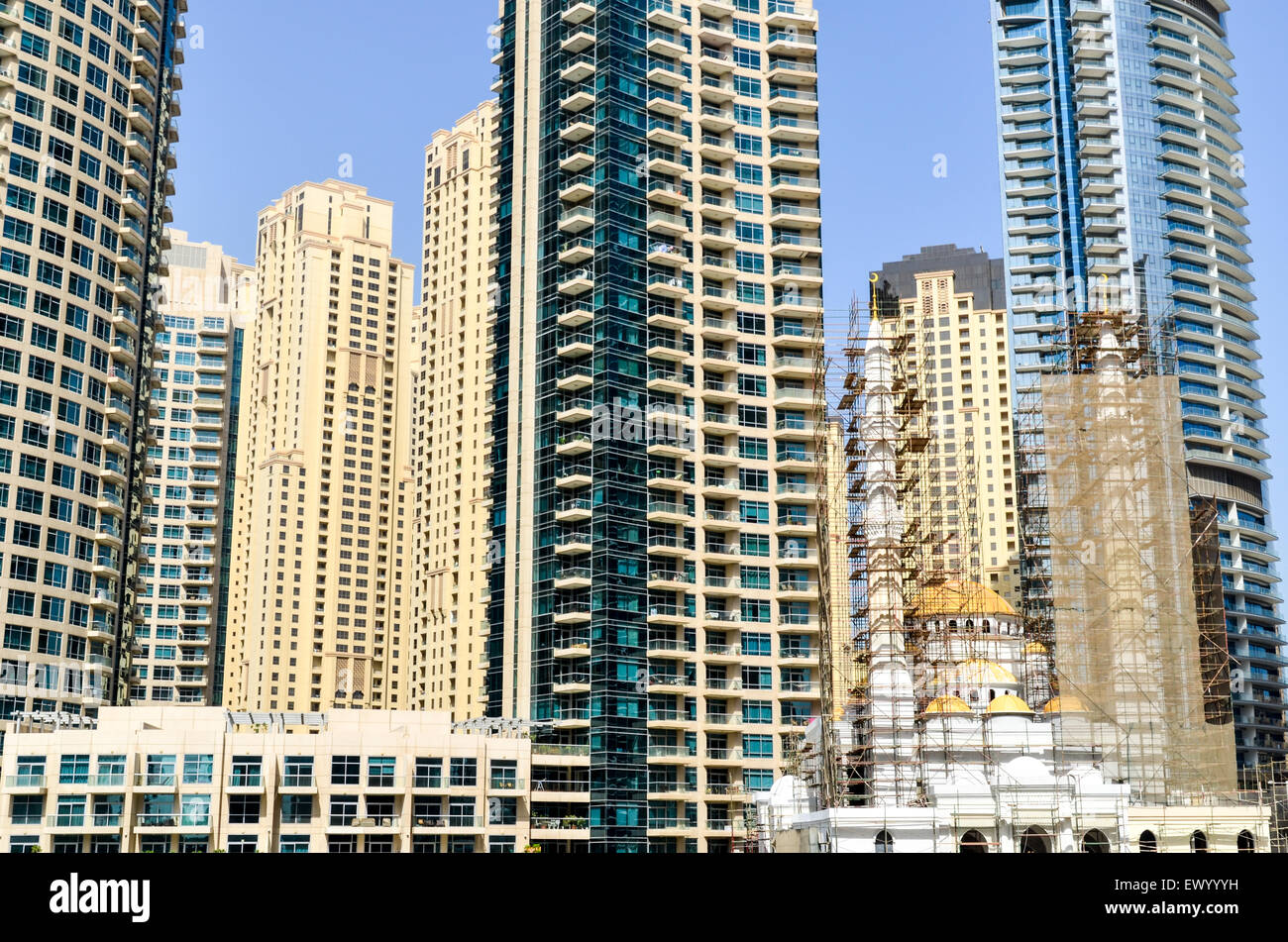 Mosque in construction among the modern high rise buildings, towers and hotels of the Dubai Marina, United Arab Emirates Stock Photo
