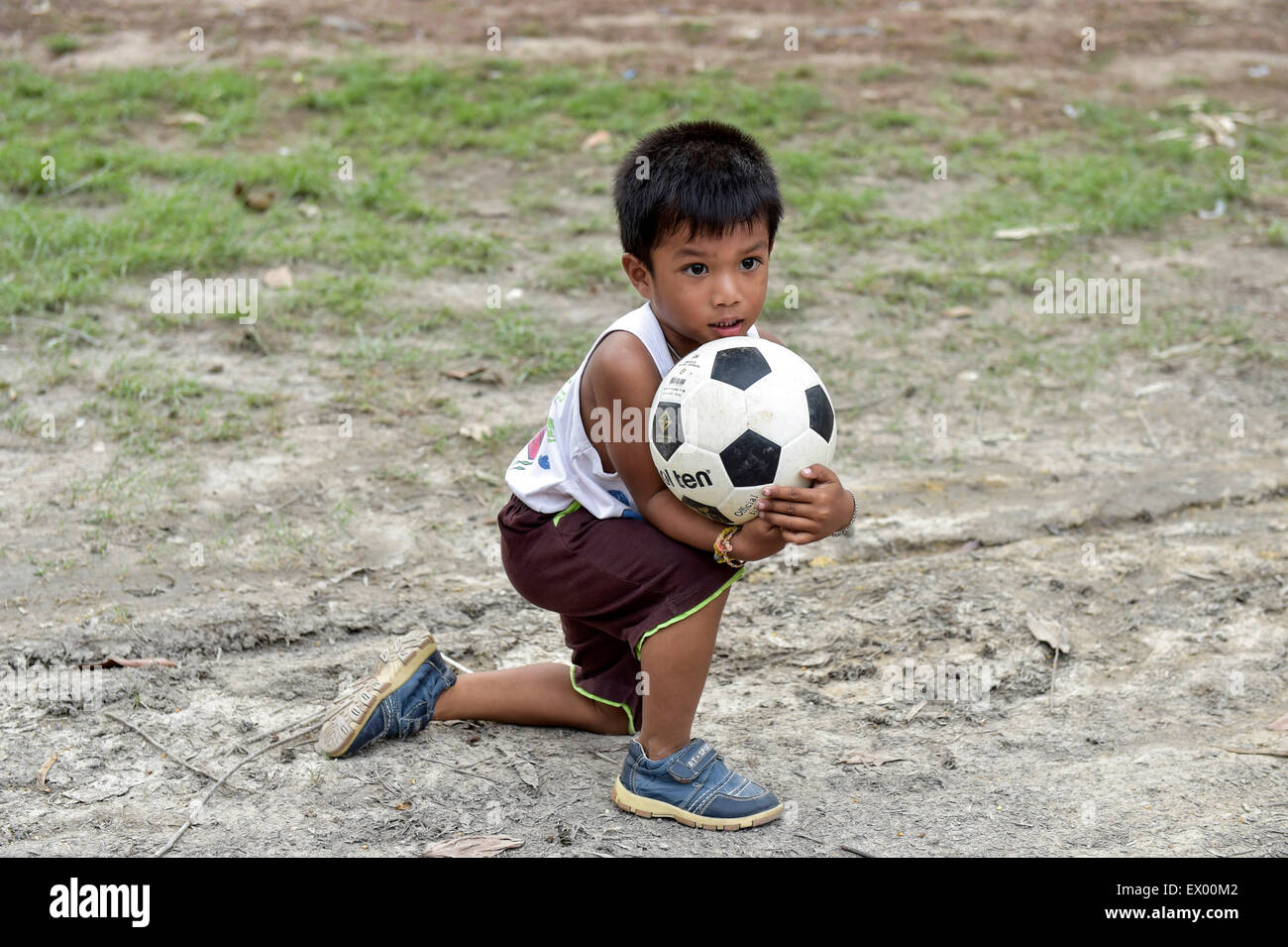 Boy with football in his arms, Ko Samui, Thailand Stock Photo Alamy