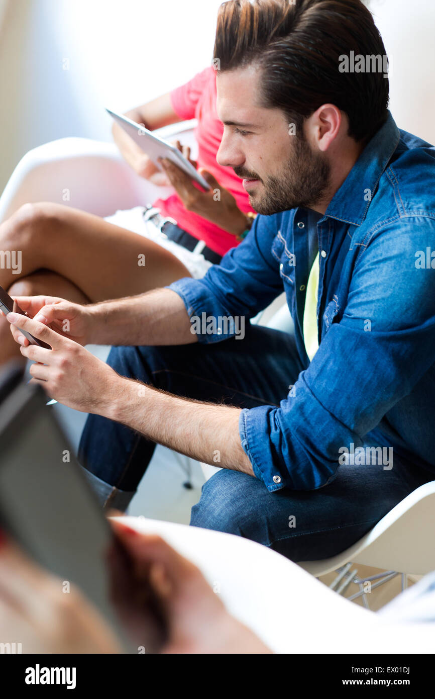 Portrait of young businessman using the mobile phone Stock Photo - Alamy
