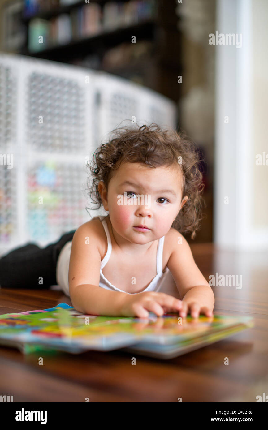Little girl reading board book Stock Photo Alamy