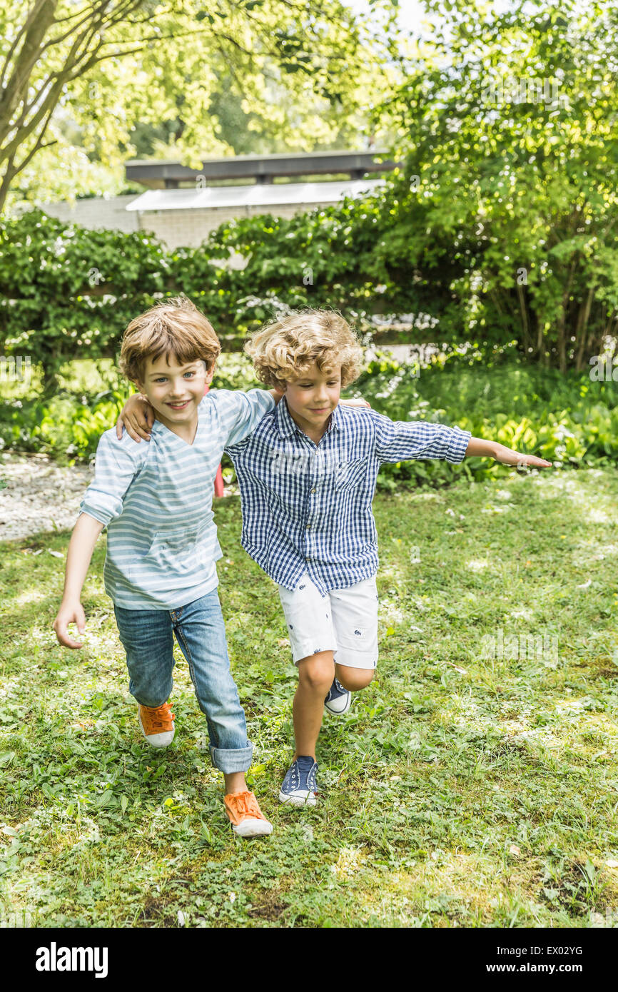 Two brothers running together in garden Stock Photo Alamy