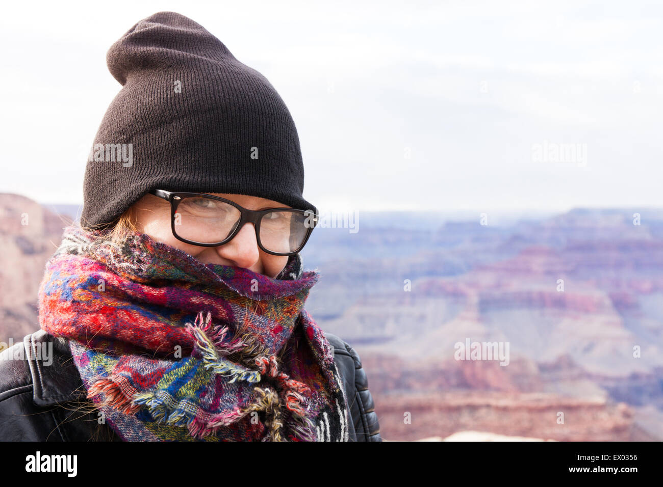 Woman wearing hat and scarf, Grand Canyon, Arizona, USA Stock Photo