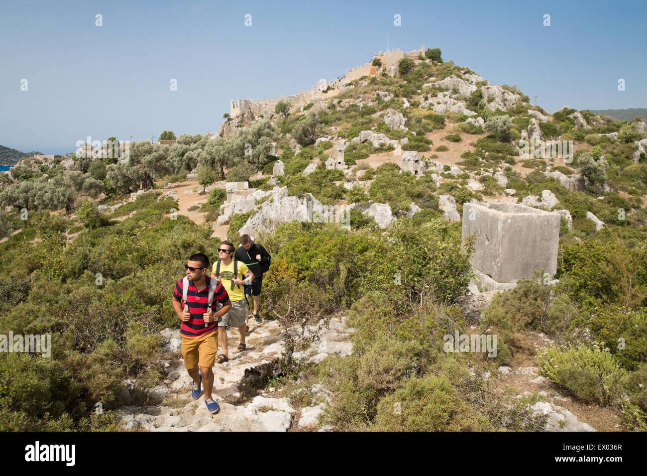 Men trekking near Tombs, Lycian way, Kalekoy, Demre, Simena, Turkey Stock Photo