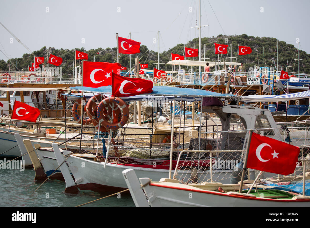 Harbor boats with Turkish flags, Kalekoy, Lycian way, Kalekoy, Demre, Simena, Turkey Stock Photo