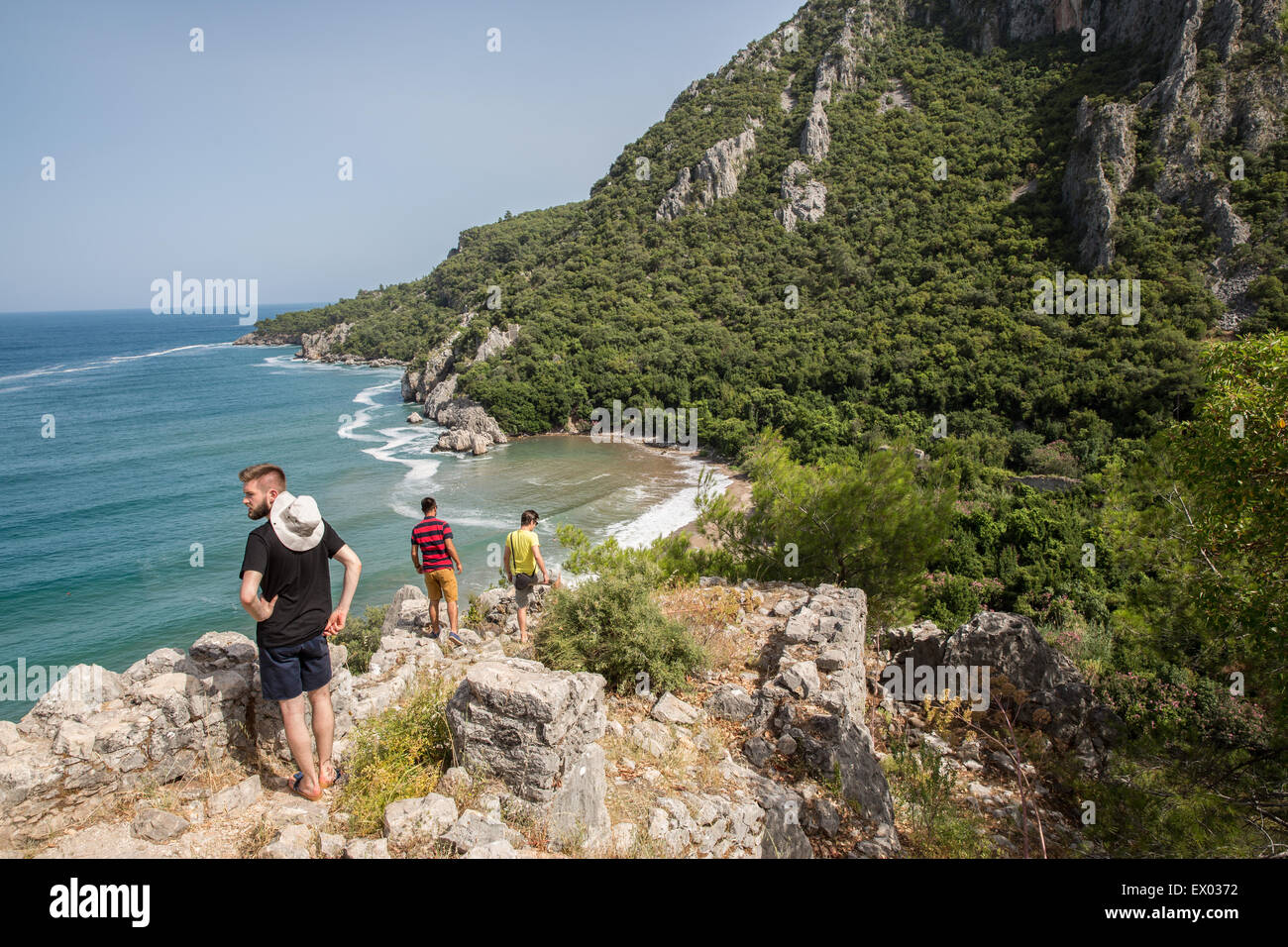 Male hikers at coast, Olympos, Lycian way, Turkey Stock Photo