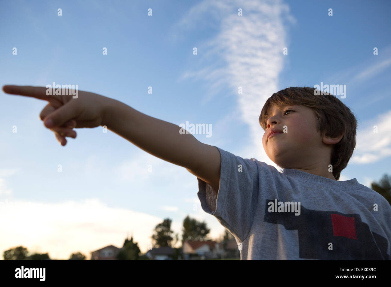 Low angle view of boy pointing finger in park Stock Photo