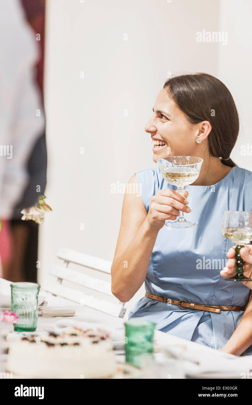 Young woman drinking wine at party Stock Photo