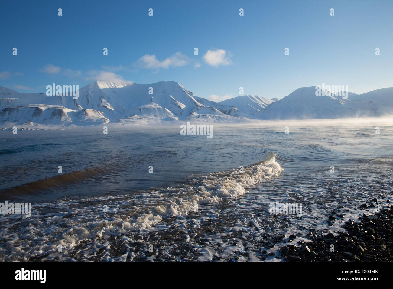 View of coast and distant mountains, Svalbard, Norway Stock Photo