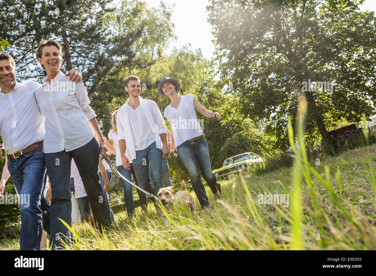 Group of people walking through forest Stock Photo