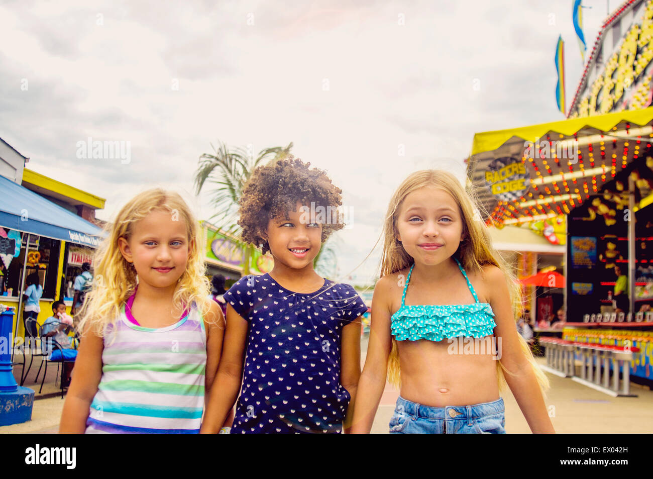 Portrait of three girls at amusement park Stock Photo