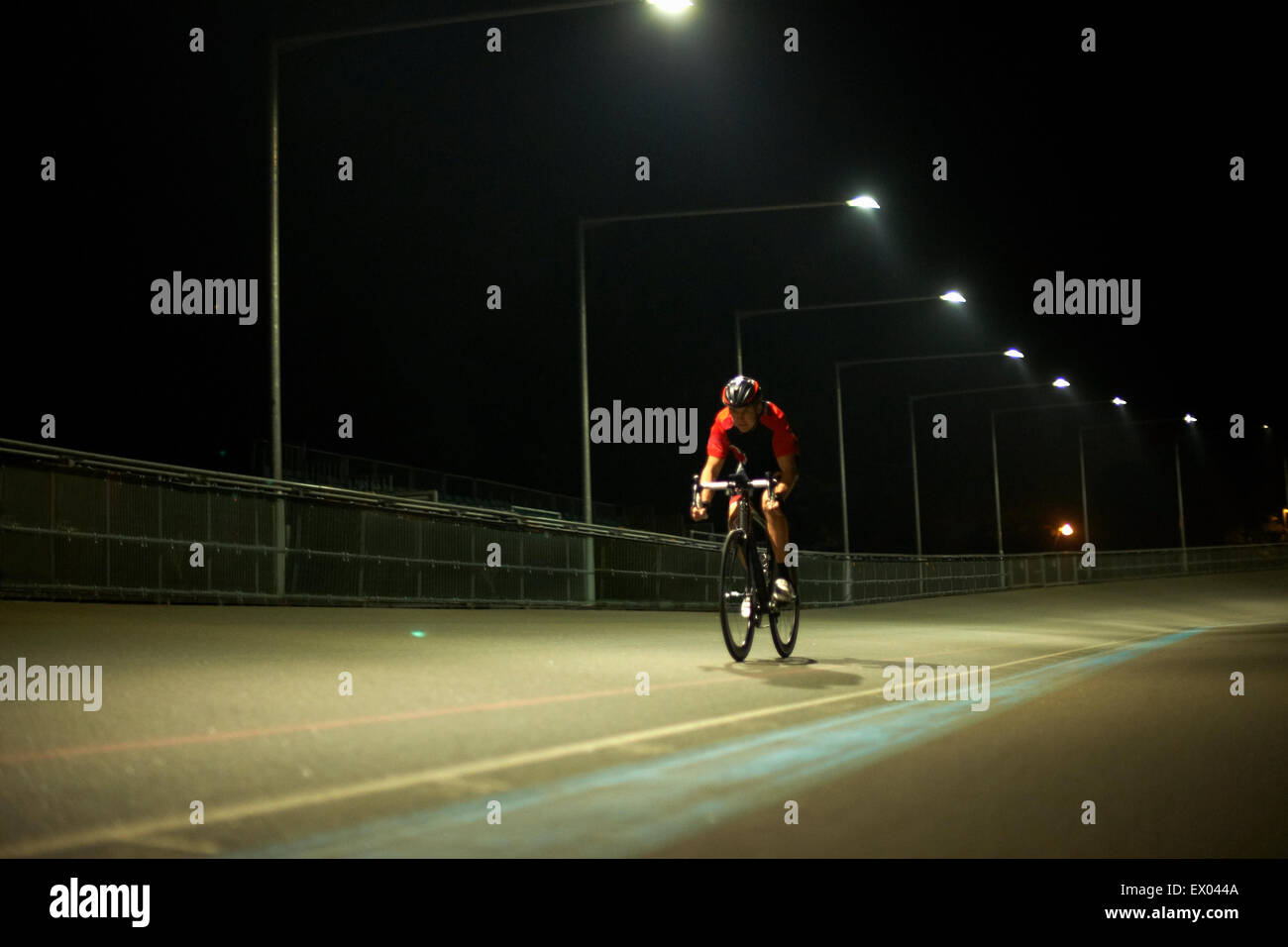 Cyclist cycling on track at velodrome, outdoors Stock Photo