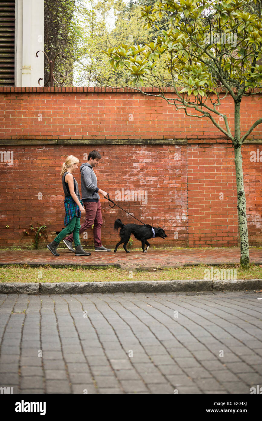 Couple walking dog on pavement, Savannah, USA Stock Photo Alamy